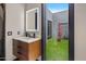 Modern bathroom with marble vanity and a view of a private backyard gym at 7223 N Black Rock Trl, Paradise Valley, AZ 85253