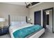 Elegant bedroom with plush bed, teal blanket, and ensuite bathroom access at 7223 N Black Rock Trl, Paradise Valley, AZ 85253