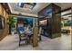 Modern dining room with a marble fireplace and glass table at 7223 N Black Rock Trl, Paradise Valley, AZ 85253