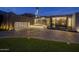 Stunning modern home exterior with a large driveway and landscaped lawn at 7223 N Black Rock Trl, Paradise Valley, AZ 85253