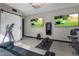 Home gym featuring exercise equipment and large TVs at 7223 N Black Rock Trl, Paradise Valley, AZ 85253