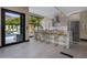 Modern kitchen with marble countertops, stainless steel appliances, and breakfast bar at 7223 N Black Rock Trl, Paradise Valley, AZ 85253