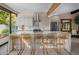 Modern kitchen with marble island and gold barstools at 7223 N Black Rock Trl, Paradise Valley, AZ 85253