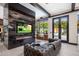 Living room with fireplace and view of the pool at 7223 N Black Rock Trl, Paradise Valley, AZ 85253