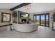 Sophisticated living room with curved sectional sofa, fireplace, and stunning views at 7223 N Black Rock Trl, Paradise Valley, AZ 85253