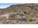 Aerial view of estate perched high on the hillside with winding drive and desert landscaping at 7929 N 55Th St, Paradise Valley, AZ 85253