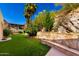 Picturesque backyard featuring artificial turf, terraced landscaping, and desert views at 7929 N 55Th St, Paradise Valley, AZ 85253