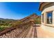 Gorgeous balcony boasts stunning desert views and ornate wrought iron railings adding to the home's elegance at 7929 N 55Th St, Paradise Valley, AZ 85253