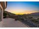 Scenic view from a balcony with decorative railings, offering a picturesque landscape of mountains and houses below at 7929 N 55Th St, Paradise Valley, AZ 85253