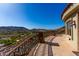 Expansive balcony features stone flooring and decorative metal railing offering panoramic mountain and city views at 7929 N 55Th St, Paradise Valley, AZ 85253