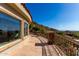 Expansive balcony features stone flooring and decorative metal railing offering mountain and city views at 7929 N 55Th St, Paradise Valley, AZ 85253