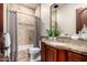 Cozy bathroom with tile, wooden cabinet, and combined bath and shower at 7929 N 55Th St, Paradise Valley, AZ 85253
