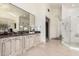 Elegant bathroom with an ornate vanity, large mirror, and walk-in shower with glass enclosure at 7929 N 55Th St, Paradise Valley, AZ 85253