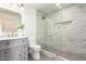 Stylish bathroom featuring a marble tiled shower with a glass enclosure, gray vanity, and modern fixtures at 7929 N 55Th St, Paradise Valley, AZ 85253