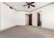 Bedroom featuring ceiling fan, crown molding, and dark wood doors at 7929 N 55Th St, Paradise Valley, AZ 85253