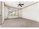 Bright bedroom with ceiling fan, crown molding, and a view of mountain landscape at 7929 N 55Th St, Paradise Valley, AZ 85253