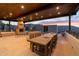 Spacious covered patio with a stone fireplace, dining table, and ample seating, great for outdoor gatherings and relaxation at 7929 N 55Th St, Paradise Valley, AZ 85253