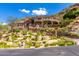 Expansive stone home with lush landscaping, multi-tiered terraces, and beautiful architectural details at 7929 N 55Th St, Paradise Valley, AZ 85253
