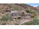 Luxury hillside home features a stone facade, arched garage, balconies, and steps to the pool at 7929 N 55Th St, Paradise Valley, AZ 85253