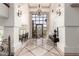 Impressive foyer with soaring ceilings, travertine floors, designer lighting, and an iron-clad entryway at 7929 N 55Th St, Paradise Valley, AZ 85253