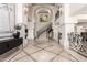 Elegant foyer features soaring ceilings, marble floors, decorative iron railings, and an art piece to accent the space at 7929 N 55Th St, Paradise Valley, AZ 85253