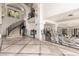 Expansive foyer with marble floors, decorative iron railings, and large windows allowing natural light to illuminate the space at 7929 N 55Th St, Paradise Valley, AZ 85253