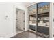 Hallway with door to bathroom and view of outdoor patio at 7929 N 55Th St, Paradise Valley, AZ 85253