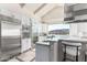 Gourmet kitchen has white cabinetry, stainless appliances and a center island at 7929 N 55Th St, Paradise Valley, AZ 85253