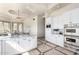Elegant kitchen features custom white cabinetry, marble countertops, stainless steel appliances and tiled flooring at 7929 N 55Th St, Paradise Valley, AZ 85253