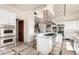 Open kitchen design with Viking appliances, a breakfast bar, white cabinets, and tile floors at 7929 N 55Th St, Paradise Valley, AZ 85253