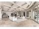Open-concept living room features coffered ceilings, marble floors, fireplace, and sliding doors to the outdoor space at 7929 N 55Th St, Paradise Valley, AZ 85253