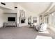 Bright and airy main bedroom featuring a fireplace, sitting area and stunning views at 7929 N 55Th St, Paradise Valley, AZ 85253