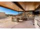 Inviting outdoor kitchen and dining area with built in barbecue, offering serene mountain views at 7929 N 55Th St, Paradise Valley, AZ 85253