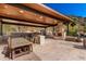 Spacious outdoor kitchen and dining area with fireplace and grill, perfect for entertaining at 7929 N 55Th St, Paradise Valley, AZ 85253