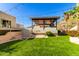 Outdoor kitchen, bar seating, and a built-in grill at 7929 N 55Th St, Paradise Valley, AZ 85253