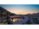 Expansive covered patio features an outdoor kitchen and overlooks the valley, perfect for entertaining and enjoying the sunset at 7929 N 55Th St, Paradise Valley, AZ 85253