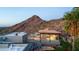 Outdoor entertainment area with a covered patio, fireplace, built-in grill, and a cozy seating area for relaxing at 7929 N 55Th St, Paradise Valley, AZ 85253