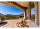 Inviting patio with stone archway, offering views of lush landscaping and scenic hills at 7929 N 55Th St, Paradise Valley, AZ 85253