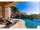 Beautiful pool area with cascading waterfall feature and lush landscaping creating a serene outdoor oasis at 7929 N 55Th St, Paradise Valley, AZ 85253