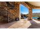 Covered patio featuring stone accents, spiral staircase, and picturesque view of the pool and surrounding landscape at 7929 N 55Th St, Paradise Valley, AZ 85253