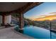 Infinity pool with stone columns provides stunning city views and a waterfall feature in a luxury outdoor space at 7929 N 55Th St, Paradise Valley, AZ 85253