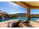 Resort-style pool area with lounge chairs and waterfall feature offering stunning panoramic views of the surrounding mountains at 7929 N 55Th St, Paradise Valley, AZ 85253