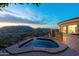 Gorgeous twilight pool and spa overlook the city, featuring iron railing and stone architecture details at 7929 N 55Th St, Paradise Valley, AZ 85253