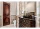 Powder room featuring dark wooden vanity and mosaic tile wall and flooring at 7929 N 55Th St, Paradise Valley, AZ 85253