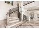 Elegant staircase has marble steps, decorative iron railings, and large windows creating a light-filled and inviting space at 7929 N 55Th St, Paradise Valley, AZ 85253