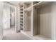Spacious walk-in closet featuring custom shelving and ample storage space for an organized wardrobe at 7929 N 55Th St, Paradise Valley, AZ 85253