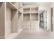 Large walk-in closet with custom cabinetry, shelving, and drawer storage for ample organization at 7929 N 55Th St, Paradise Valley, AZ 85253
