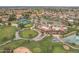 Community aerial view showcasing golf course, tennis courts, clubhouse, and scenic ponds at 9447 W Tonto Ln, Peoria, AZ 85382