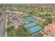 Overhead view of tennis courts and lush landscaping within a golf course community at 9447 W Tonto Ln, Peoria, AZ 85382
