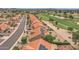 Aerial shot of houses with solar panels along a golf course, showcasing neighborhood layout at 9447 W Tonto Ln, Peoria, AZ 85382